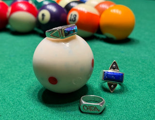 CHIDA Gems sterling silver rings with lapis lazuli and turquoise gemstones displayed on billiard balls